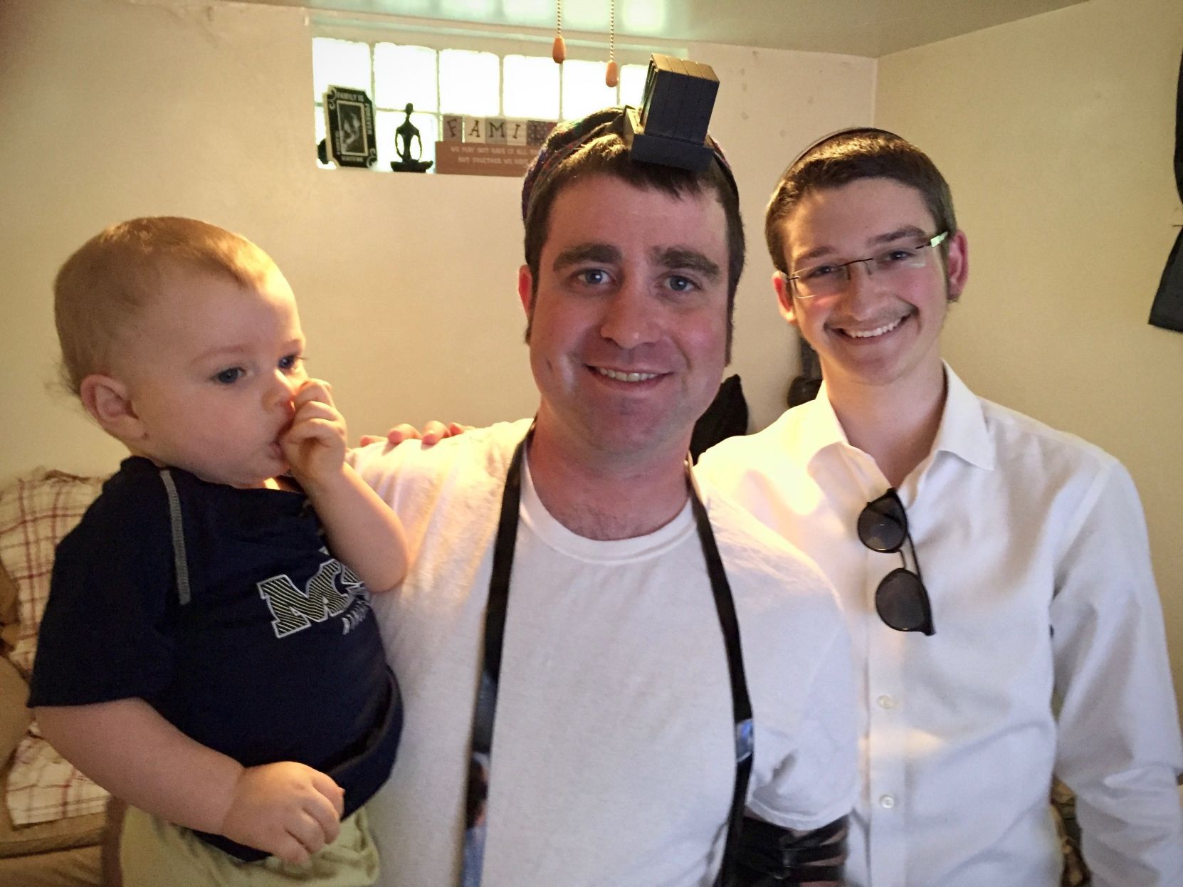 Daniel Lord, center, wears tefillin